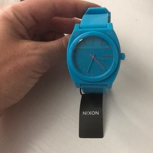 Bright blue Nixon watch with pink numbers